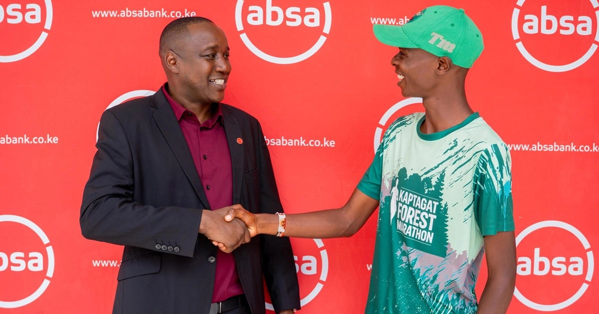 Absa Bank Kenya Regional Manager Timothy Kosgey handshakes a local athlete during the launch of the inaugural Absa Eldoret City Run.