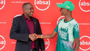 Absa Bank Kenya Regional Manager Timothy Kosgey handshakes a local athlete during the launch of the inaugural Absa Eldoret City Run.
