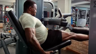 Kenyan bodybuilder Antony Gachau performing leg extensions at the gym
