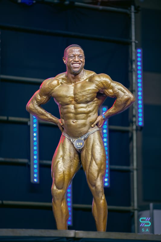 Gachau Njoroge smiling while posing at MMEA 2024 fitness event