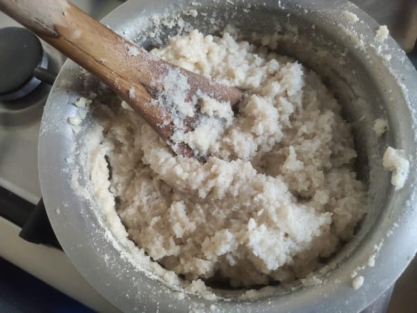 Stirring ugali with a wooden spoon (mwiko) as it thickens