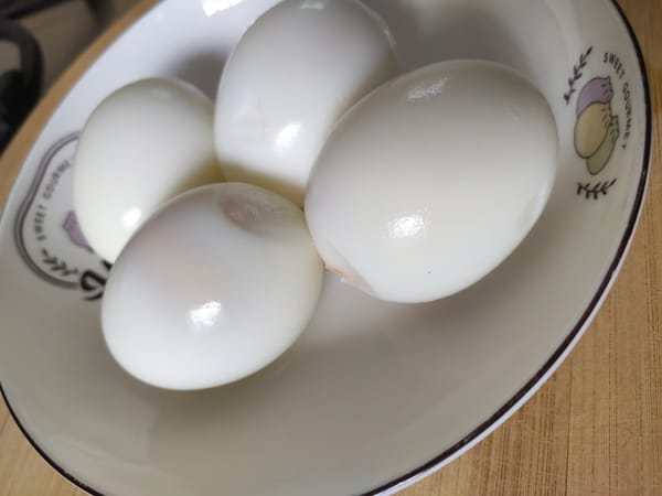 Glossy hard-boiled and peeled kienyeji eggs served as a Kenyan breakfast side dish