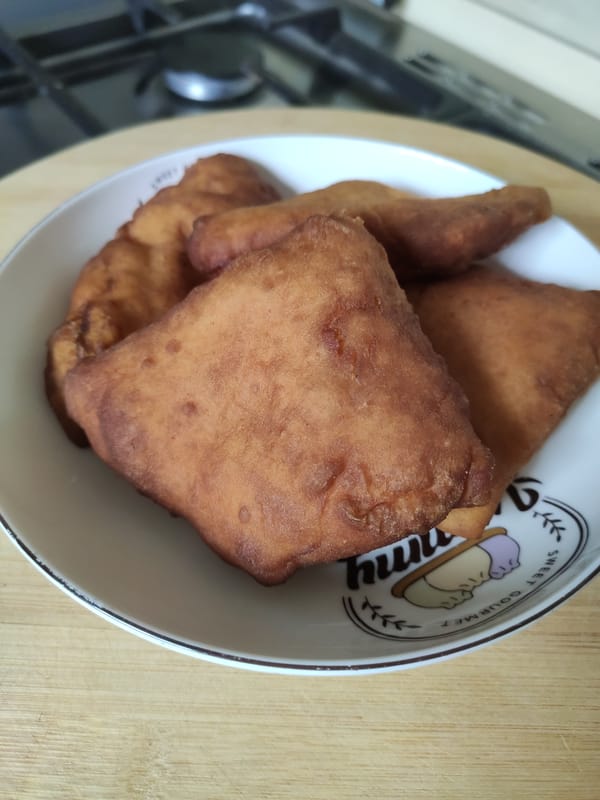 Close-up of soft and fluffy Kenyan mandazi showing the fried crust