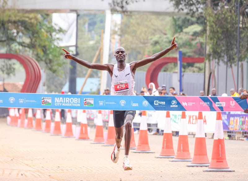 Enock Kipkemboi crosses the finish line to win the men