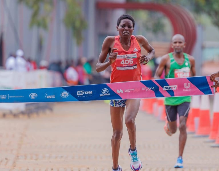 Joy Kemuma breaks the tape to win the women