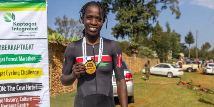 Kendra Masika holds her medal after winning the elite women
