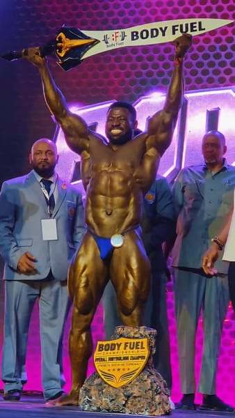 King Cobra raising his Overall Bodybuilding trophy at Body Fuel Championship 2026