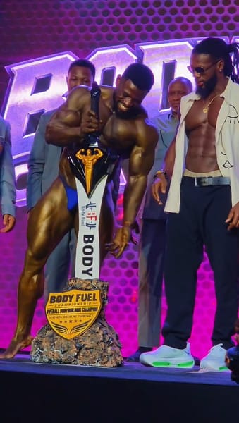 King Cobra holding his overall trophy beside Ulisses Jr. at Body Fuel Championship 2026