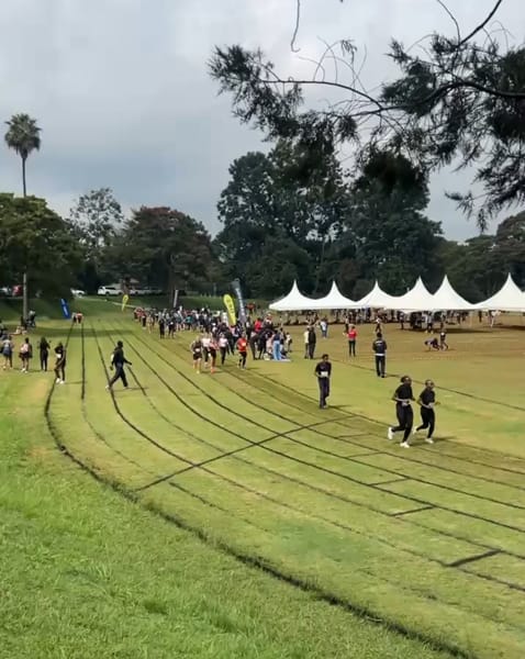 Participants on the running track at KSTVET in Gigiri during a Hy.brid event