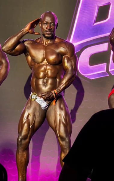 Peter Ochino saluting onstage at Body Fuel Championship 2026